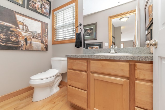 6833 Strawberry Lake Rd, Whitmore Lake, MI 48189 - bathroom featuring wood finished floors, toilet, baseboards, and vanity