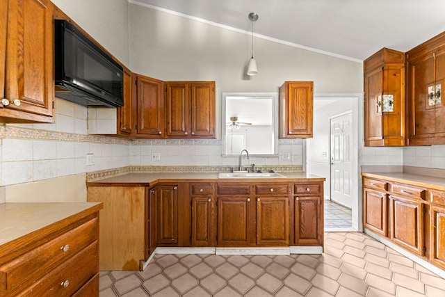 80 E Mahan Ave, Hazel Park, MI 48030 - kitchen with a sink, black microwave, lofted ceiling, crown molding, and brown cabinets