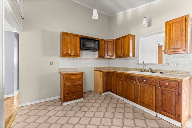 80 E Mahan Ave, Hazel Park, MI 48030 - kitchen with black microwave, a sink, brown cabinetry, light flooring, and ornamental molding