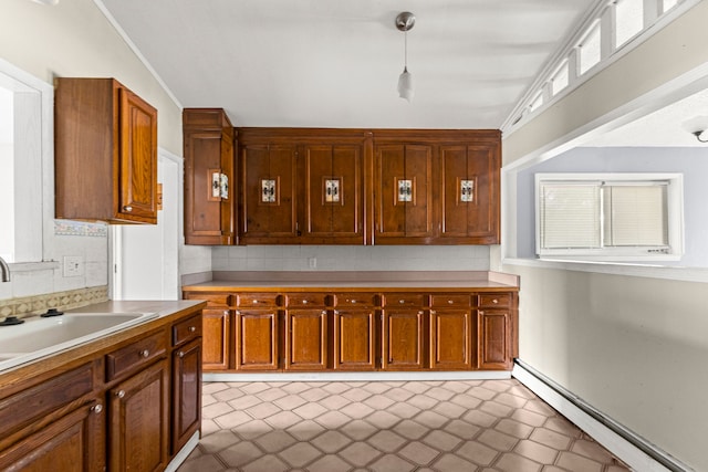 80 E Mahan Ave, Hazel Park, MI 48030 - kitchen featuring a baseboard heating unit, light countertops, decorative backsplash, and brown cabinets