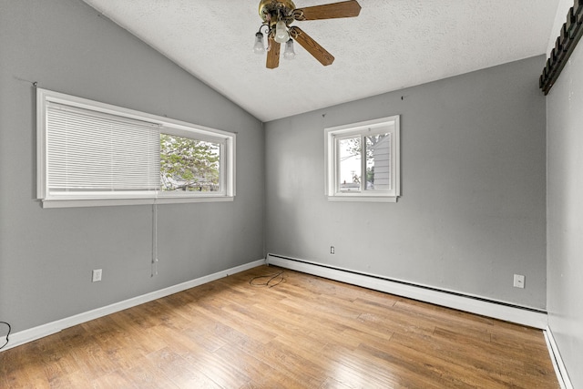 80 E Mahan Ave, Hazel Park, MI 48030 - unfurnished room with baseboard heating, a ceiling fan, vaulted ceiling, wood finished floors, and a textured ceiling