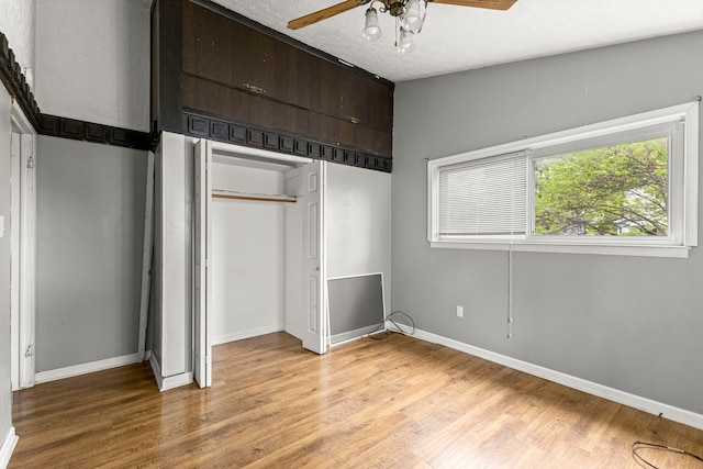 80 E Mahan Ave, Hazel Park, MI 48030 - unfurnished bedroom with light wood-style flooring, baseboards, a ceiling fan, a closet, and a textured ceiling