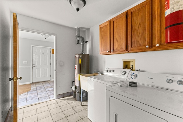 80 E Mahan Ave, Hazel Park, MI 48030 - laundry area featuring cabinet space, washer and clothes dryer, water heater, and light tile patterned floors