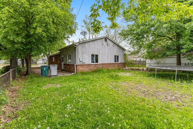 80 E Mahan Ave, Hazel Park, MI 48030 - back of house featuring a trampoline and brick siding
