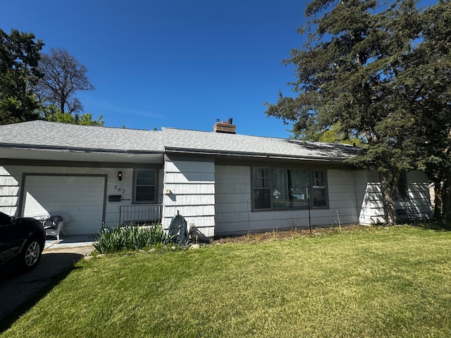 563 Walnut St, Mount Morris, MI 48458 - single story home featuring a garage, a front yard, a chimney, and roof with shingles