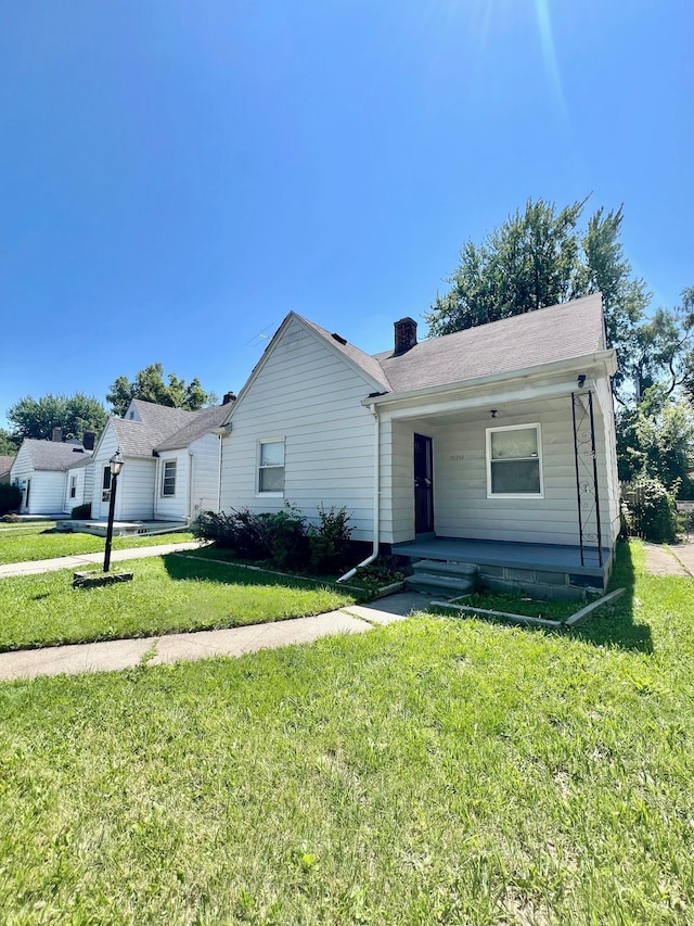 20244 Mccormick St, Detroit, MI 48224 - single story home featuring a porch, a front lawn, and a chimney