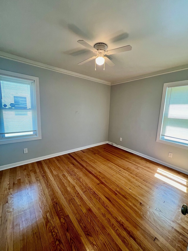 20244 Mccormick St, Detroit, MI 48224 - unfurnished room with healthy amount of natural light, crown molding, a ceiling fan, and wood finished floors