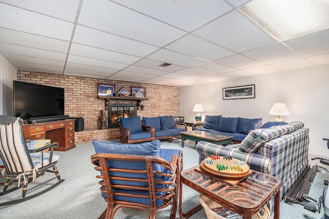 925 Plym Rd, Niles, MI 49120 - living area featuring a paneled ceiling, carpet floors, a brick fireplace, and brick wall