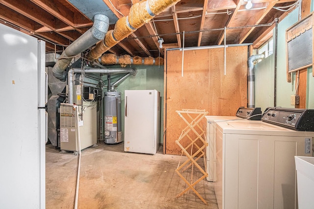 925 Plym Rd, Niles, MI 49120 - unfinished below grade area with water heater, washer and dryer, freestanding refrigerator, and heating unit