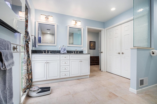 925 Plym Rd, Niles, MI 49120 - bathroom with double vanity, tile patterned flooring, and a walk in shower