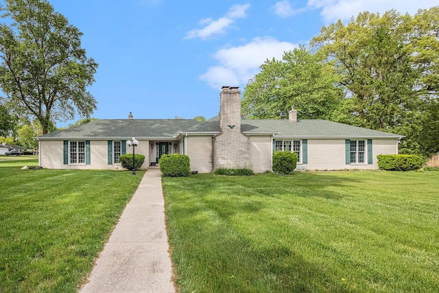 925 Plym Rd, Niles, MI 49120 - ranch-style home with brick siding, a front yard, a chimney, and a shingled roof
