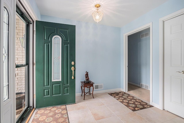 925 Plym Rd, Niles, MI 49120 - entryway featuring a chandelier, light tile patterned flooring, and baseboards
