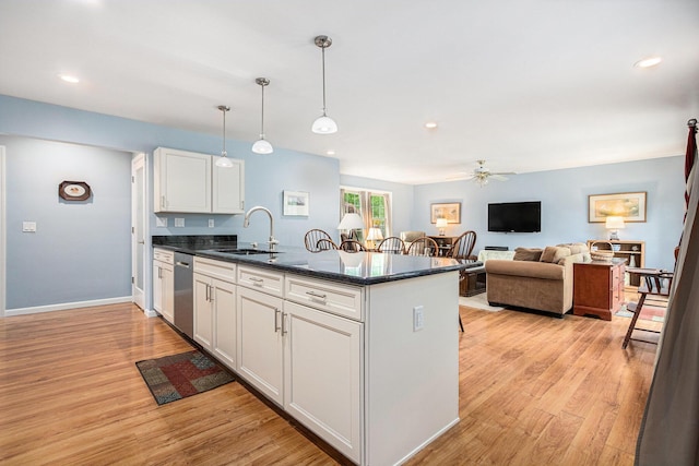 925 Plym Rd, Niles, MI 49120 - kitchen with a sink, a peninsula, a ceiling fan, white cabinets, and light wood-type flooring