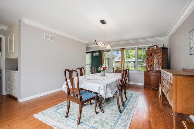 925 Plym Rd, Niles, MI 49120 - dining area featuring crown molding, wood finished floors, baseboards, and a chandelier