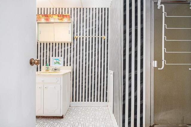 925 Plym Rd, Niles, MI 49120 - bathroom with wallpapered walls, vanity, and baseboards