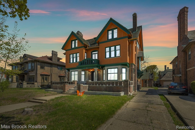 94 E Boston Blvd, Detroit, MI 48202 - view of front facade featuring a chimney, stucco siding, and brick siding