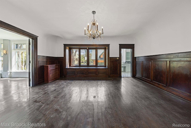 94 E Boston Blvd, Detroit, MI 48202 - unfurnished dining area with a wainscoted wall, dark wood-type flooring, a chandelier, and plenty of natural light