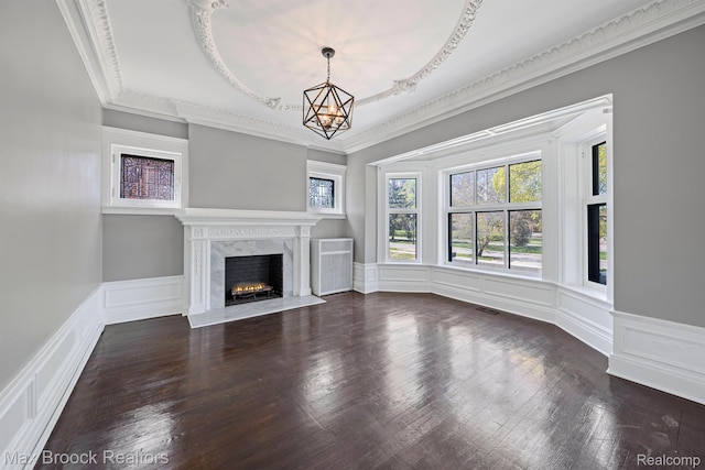 94 E Boston Blvd, Detroit, MI 48202 - unfurnished living room featuring a chandelier, a fireplace, ornamental molding, a decorative wall, and wainscoting