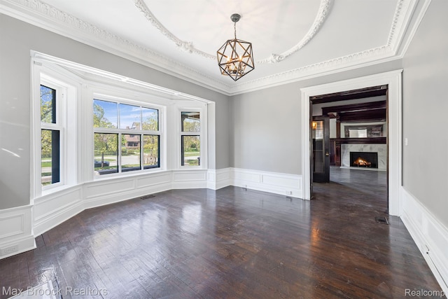 94 E Boston Blvd, Detroit, MI 48202 - unfurnished room featuring a chandelier, a decorative wall, wainscoting, a lit fireplace, and dark wood finished floors