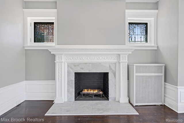 94 E Boston Blvd, Detroit, MI 48202 - detailed view of a fireplace, wood finished floors, a wainscoted wall, and a decorative wall
