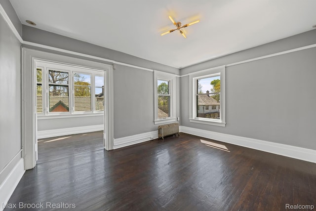 94 E Boston Blvd, Detroit, MI 48202 - unfurnished room featuring radiator, healthy amount of natural light, and wood finished floors