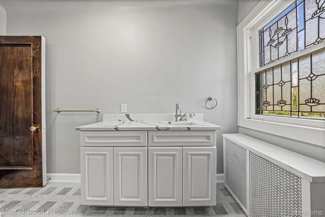 94 E Boston Blvd, Detroit, MI 48202 - bathroom featuring radiator and double vanity