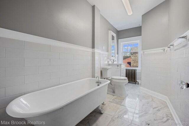 94 E Boston Blvd, Detroit, MI 48202 - full bathroom with radiator heating unit, tile walls, a freestanding tub, marble finish flooring, and wainscoting