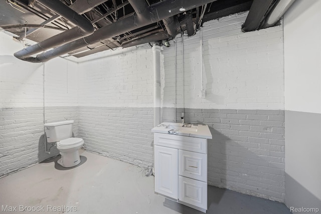 94 E Boston Blvd, Detroit, MI 48202 - bathroom with vanity, concrete floors, and brick wall