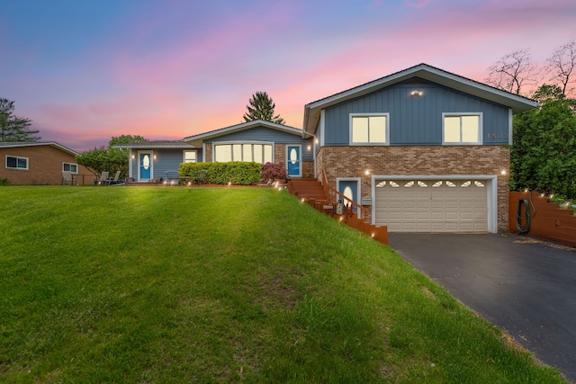 1533 Walton Blvd, Rochester Hills, MI 48309 - view of front of property with asphalt driveway, brick siding, an attached garage, and a lawn