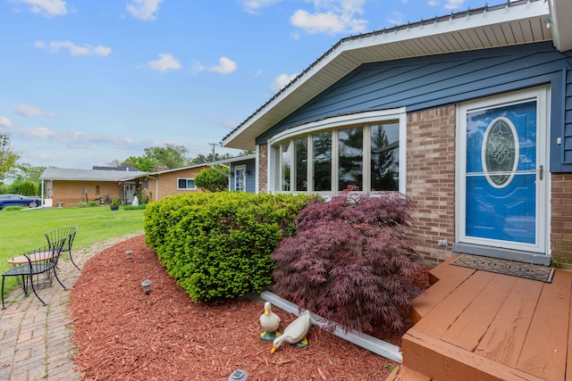 1533 Walton Blvd, Rochester Hills, MI 48309 - view of property exterior featuring a lawn and brick siding