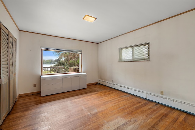 6351 Alden Dr, West Bloomfield, MI 48324 - unfurnished bedroom with a baseboard radiator, light wood-style floors, ornamental molding, a closet, and baseboards