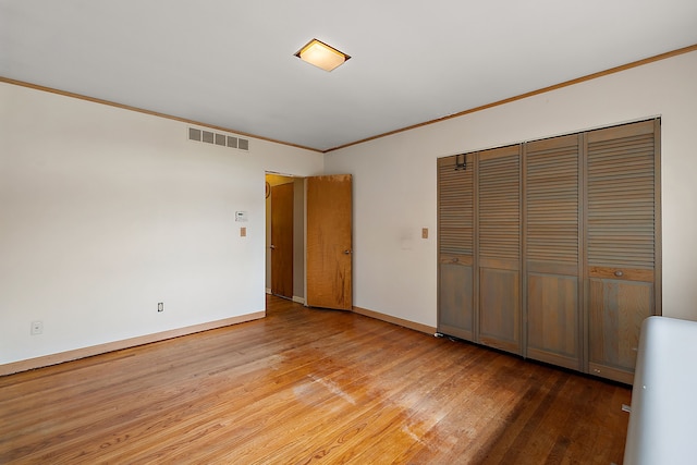 6351 Alden Dr, West Bloomfield, MI 48324 - unfurnished bedroom with wood finished floors, crown molding, a closet, and baseboards
