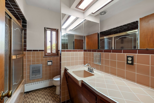 6351 Alden Dr, West Bloomfield, MI 48324 - full bathroom featuring baseboard heating, heating unit, tile walls, toilet, and tile patterned floors