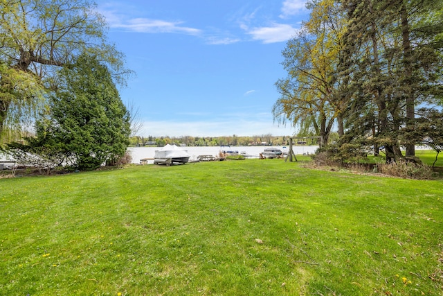 6351 Alden Dr, West Bloomfield, MI 48324 - view of green lawn with a water view and a boat dock