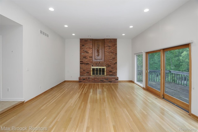 5844 Independence Ln, West Bloomfield, MI 48322 - unfurnished living room featuring light wood-style floors, recessed lighting, baseboards, and a brick fireplace
