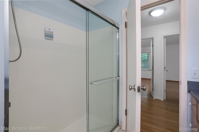 5844 Independence Ln, West Bloomfield, MI 48322 - full bathroom featuring a stall shower, wood finished floors, vanity, and baseboards