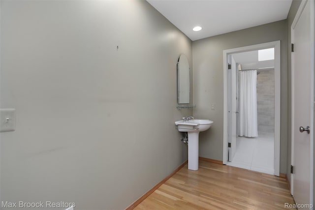 5844 Independence Ln, West Bloomfield, MI 48322 - bathroom featuring wood finished floors, baseboards, a sink, and recessed lighting