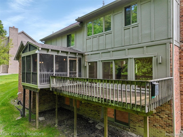 5844 Independence Ln, West Bloomfield, MI 48322 - back of house featuring a sunroom, board and batten siding, a wooden deck, and brick siding