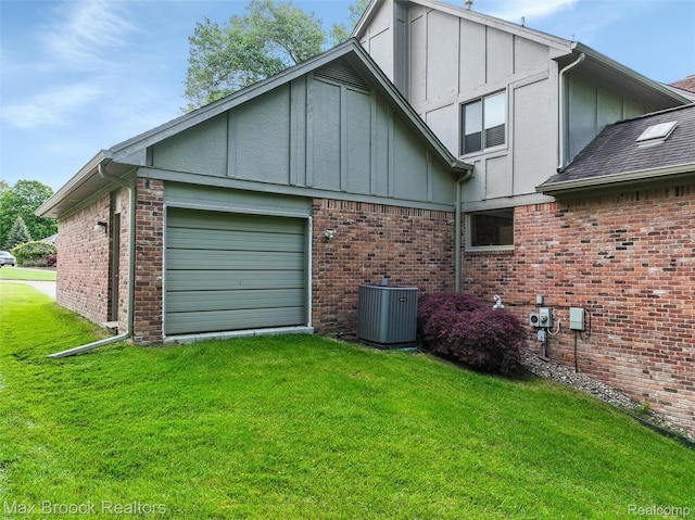 5844 Independence Ln, West Bloomfield, MI 48322 - view of side of property featuring board and batten siding, central AC, a garage, a yard, and brick siding