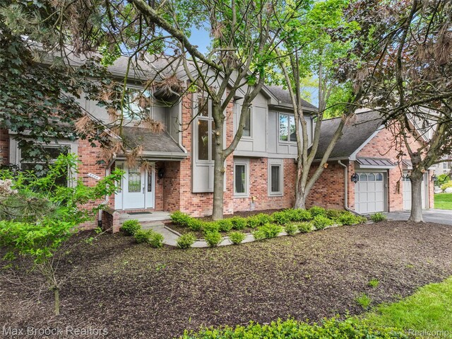 5844 Independence Ln, West Bloomfield, MI 48322 - view of front of house with brick siding, a shingled roof, driveway, and a garage