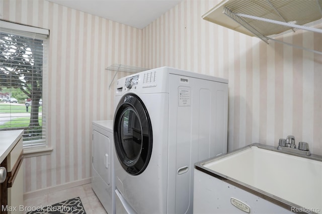 5844 Independence Ln, West Bloomfield, MI 48322 - laundry room featuring washing machine and dryer, light tile patterned floors, and baseboards