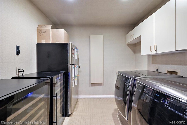 4889 Ardmore Dr, Bloomfield Hills, MI 48302 - laundry room with cabinet space, washer and clothes dryer, baseboards, and light tile patterned floors