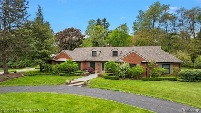 4889 Ardmore Dr, Bloomfield Hills, MI 48302 - view of front of property featuring a front yard, a chimney, and brick siding