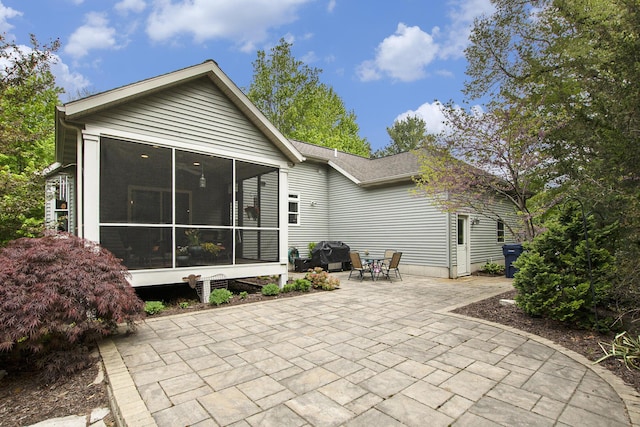 6371 Colorado Ct, Norton Shores, MI 49441 - rear view of house featuring a patio area and a sunroom