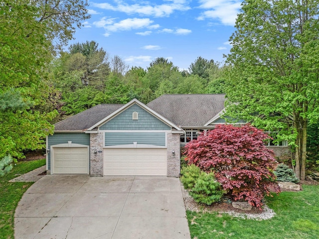 6371 Colorado Ct, Norton Shores, MI 49441 - view of front of property featuring a garage, concrete driveway, and brick siding