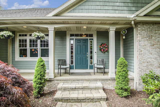 6371 Colorado Ct, Norton Shores, MI 49441 - view of exterior entry featuring covered porch and brick siding
