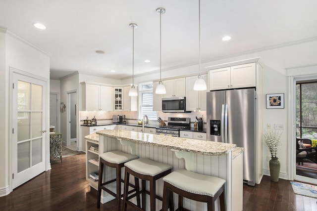 6371 Colorado Ct, Norton Shores, MI 49441 - kitchen with appliances with stainless steel finishes, decorative backsplash, a kitchen island, plenty of natural light, and crown molding