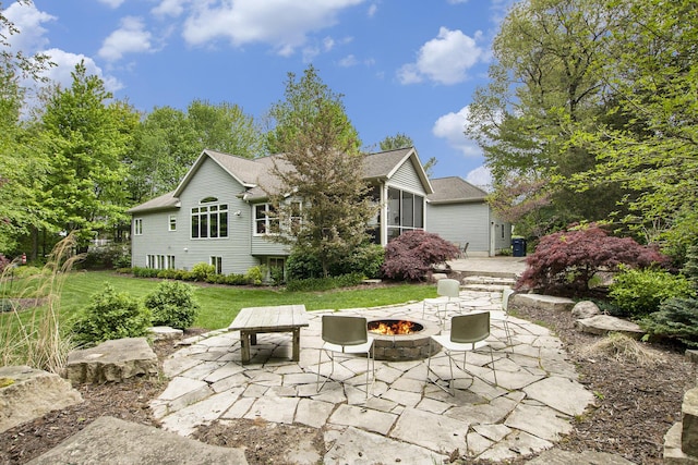 6371 Colorado Ct, Norton Shores, MI 49441 - back of property with a fire pit, a patio area, and a lawn