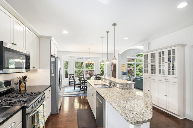 6371 Colorado Ct, Norton Shores, MI 49441 - kitchen with appliances with stainless steel finishes, a sink, an island with sink, arched walkways, and recessed lighting