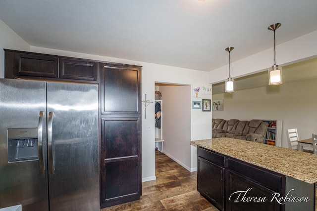 4240 Butternut Dr, Wayland, MI 49348 - kitchen with stainless steel refrigerator with ice dispenser, dark wood-type flooring, light stone counters, pendant lighting, and baseboards